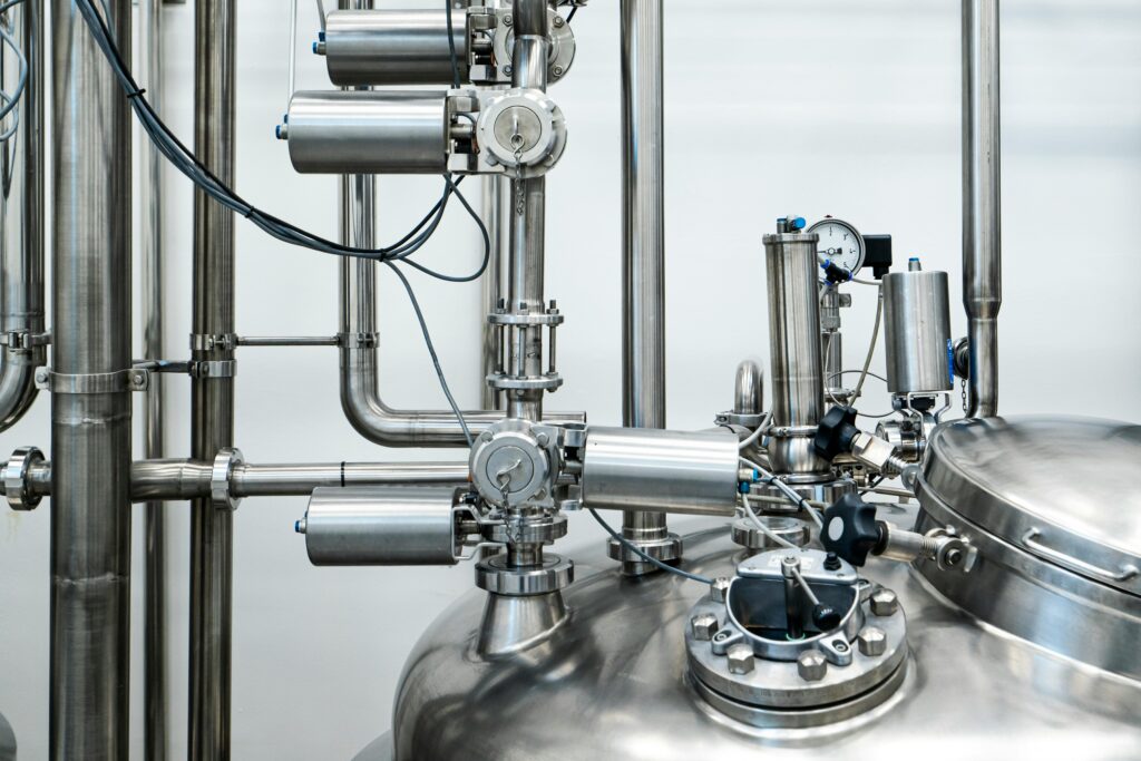 project-4 Close-up of stainless steel machinery and pipes in an industrial setting, showcasing modern engineering.